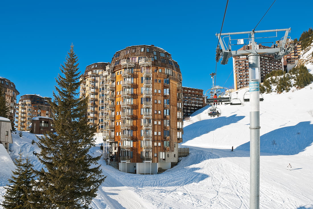 Ski lift and view of Avoriaz town in Alps
